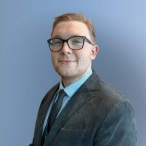 Finlay headshot, blue grey background