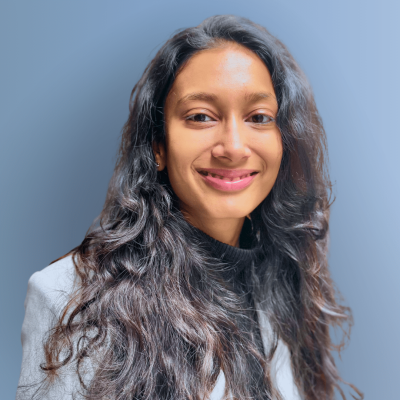 Asmi headshot blue grey background